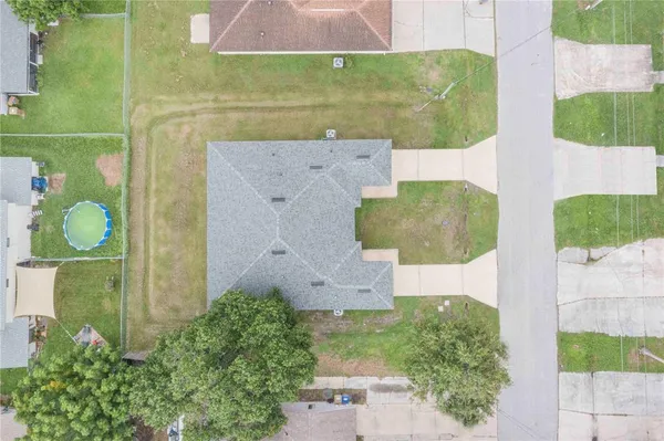 an aerial view of a house with a swimming pool
