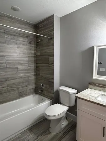 a bathroom with a toilet a sink and bathtub