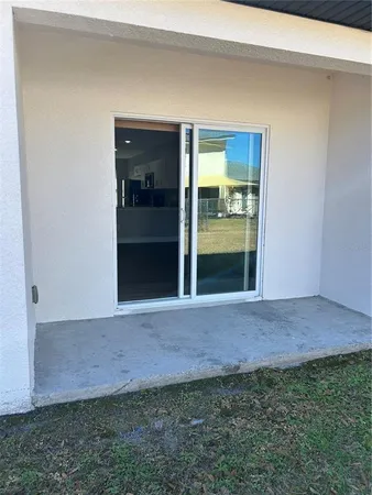 a view of an empty room with a kitchen
