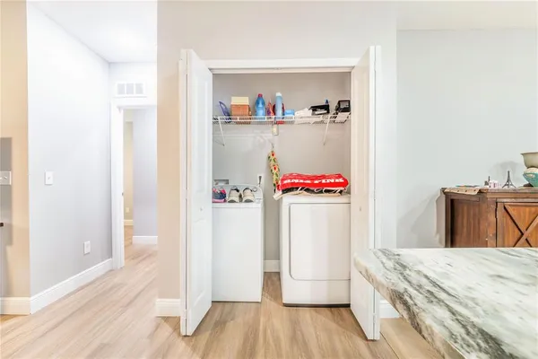 a room with a bed and a wooden floor