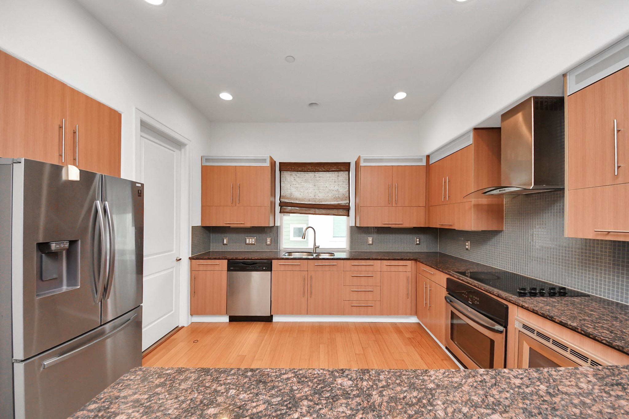 1403 Delano Street, Unit 6 Houston, TX 77003 - Photo 15 of 46 a kitchen with granite countertop stainless steel appliances a sink a counter top space and cabinets
