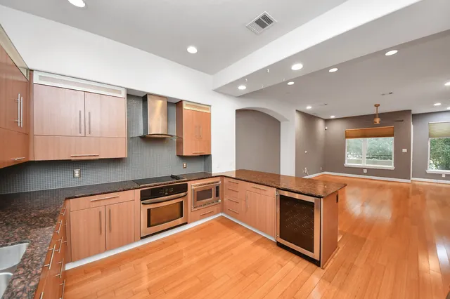 a kitchen with stainless steel appliances granite countertop a sink and cabinets