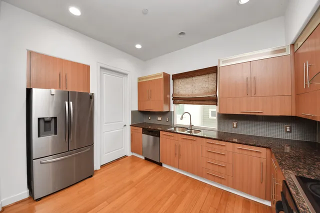 a kitchen with stainless steel appliances granite countertop a refrigerator sink and cabinets