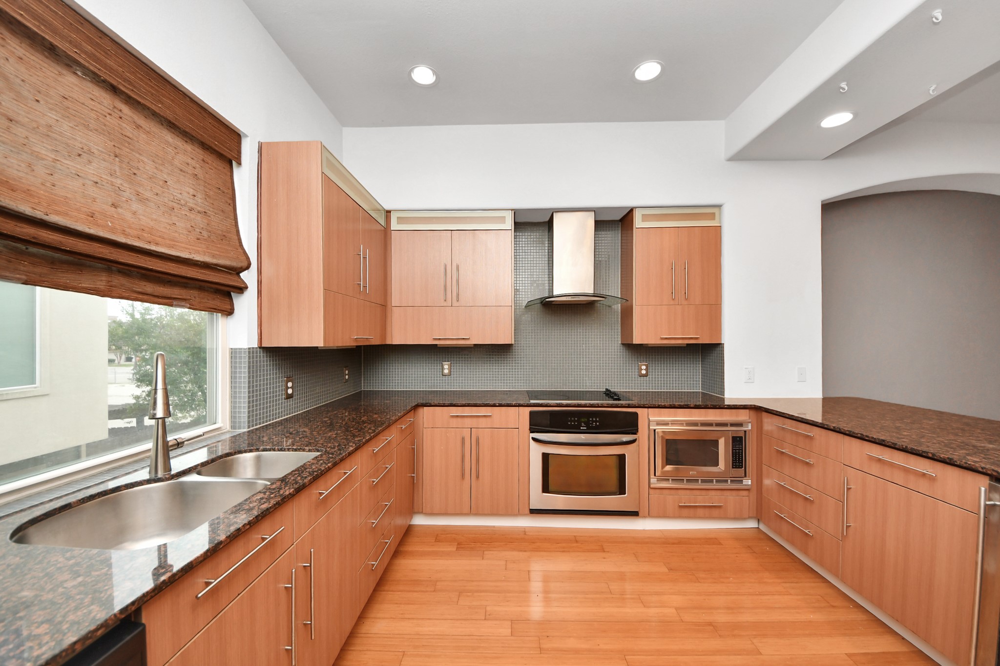 1403 Delano Street, Unit 6 Houston, TX 77003 - Photo 18 of 46 a large kitchen with stainless steel appliances granite countertop a sink stove and cabinets
