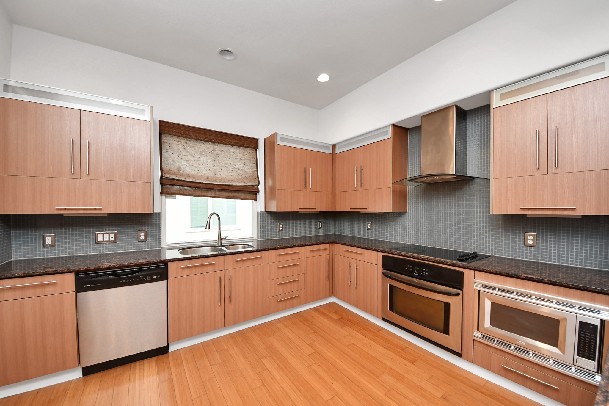 1403 Delano Street, Unit 6 Houston, TX 77003 - Photo 19 of 46 a kitchen with granite countertop cabinets stainless steel appliances and a sink