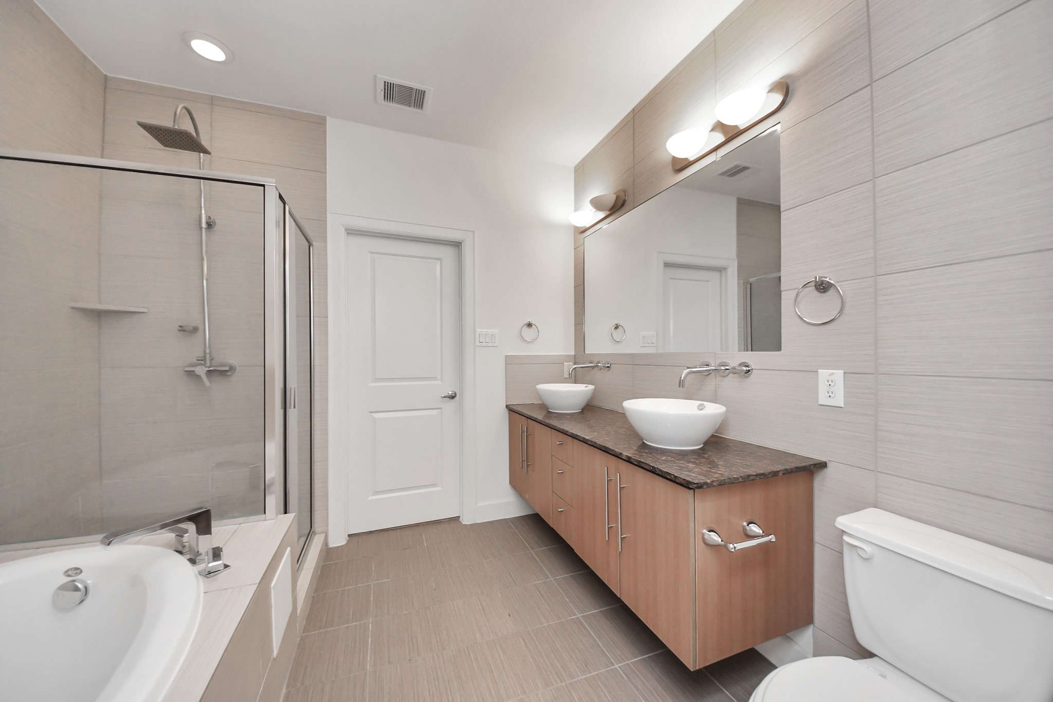 1403 Delano Street, Unit 6 Houston, TX 77003 - Photo 27 of 46 a bathroom with a granite countertop sink mirror and a bathtub