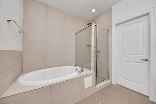 a white bath tub sitting next to a shower