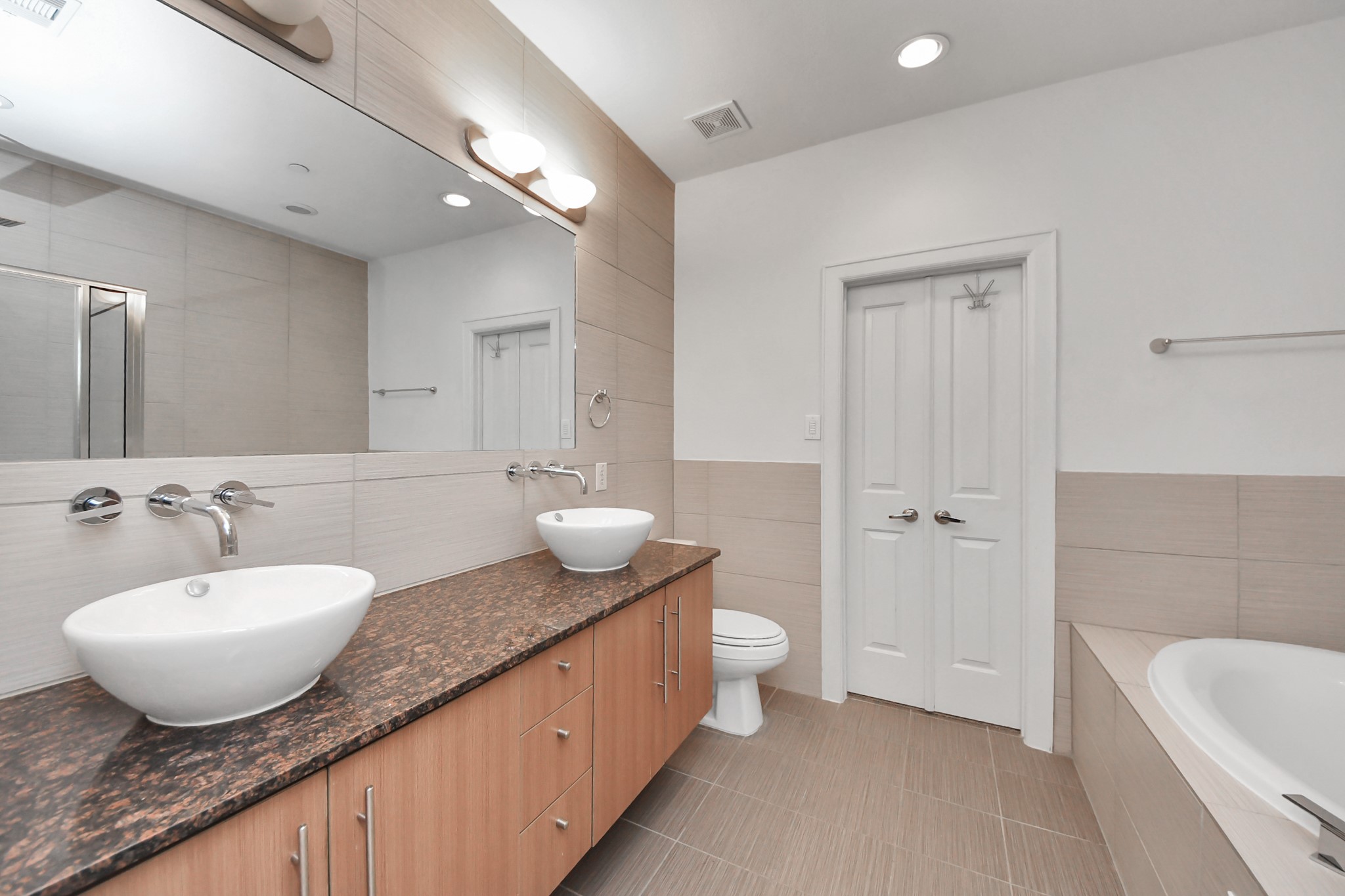 1403 Delano Street, Unit 6 Houston, TX 77003 - Photo 29 of 46 a spacious bathroom with a granite countertop sink and mirror