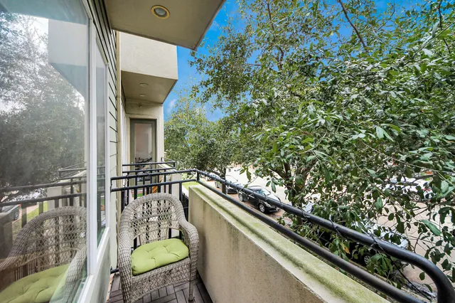 a balcony with table and chairs