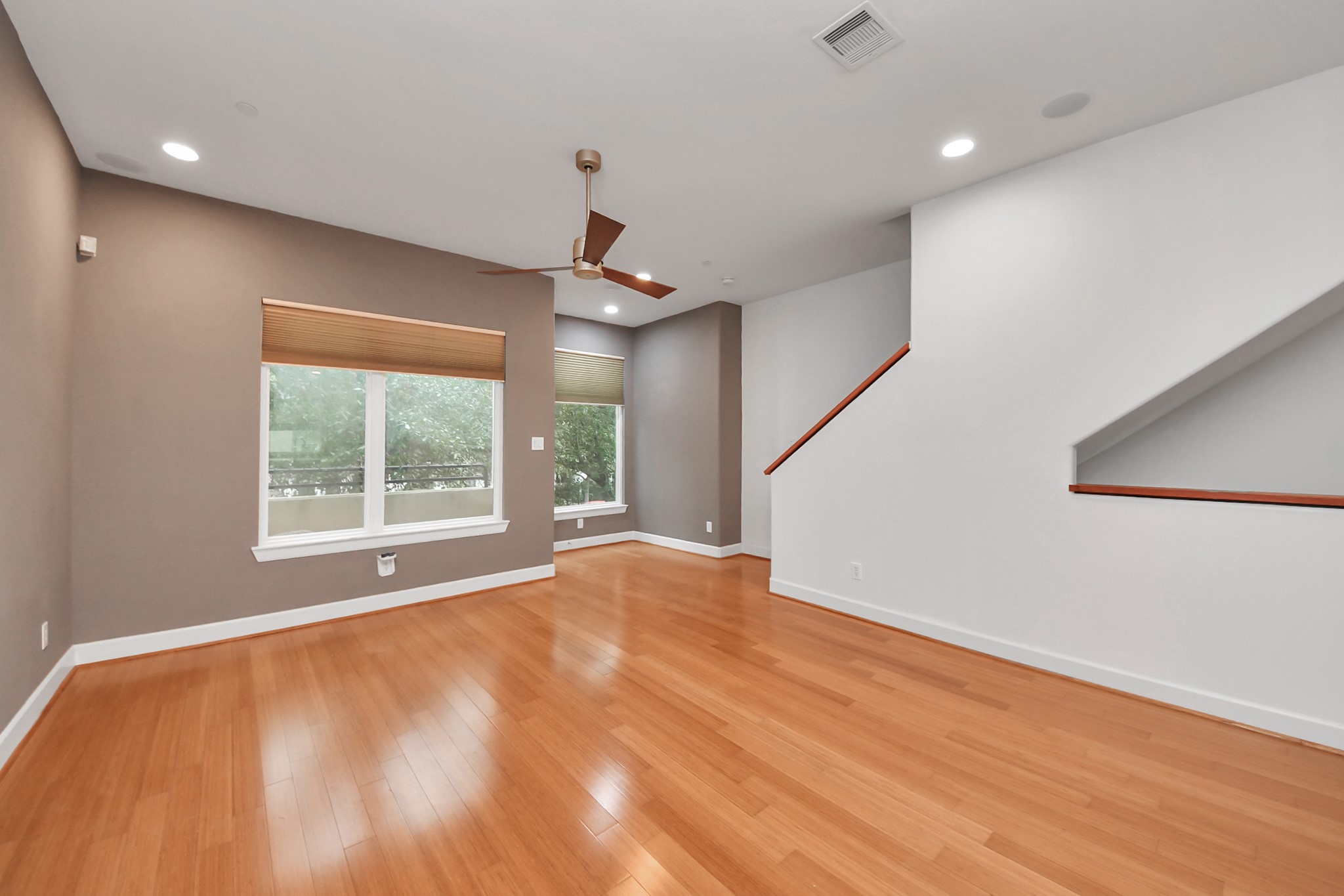 1403 Delano Street, Unit 6 Houston, TX 77003 - Photo 7 of 46 a view of an empty room with wooden floor and a window