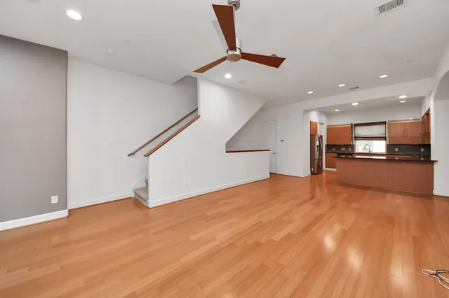 a view of empty room with wooden floor
