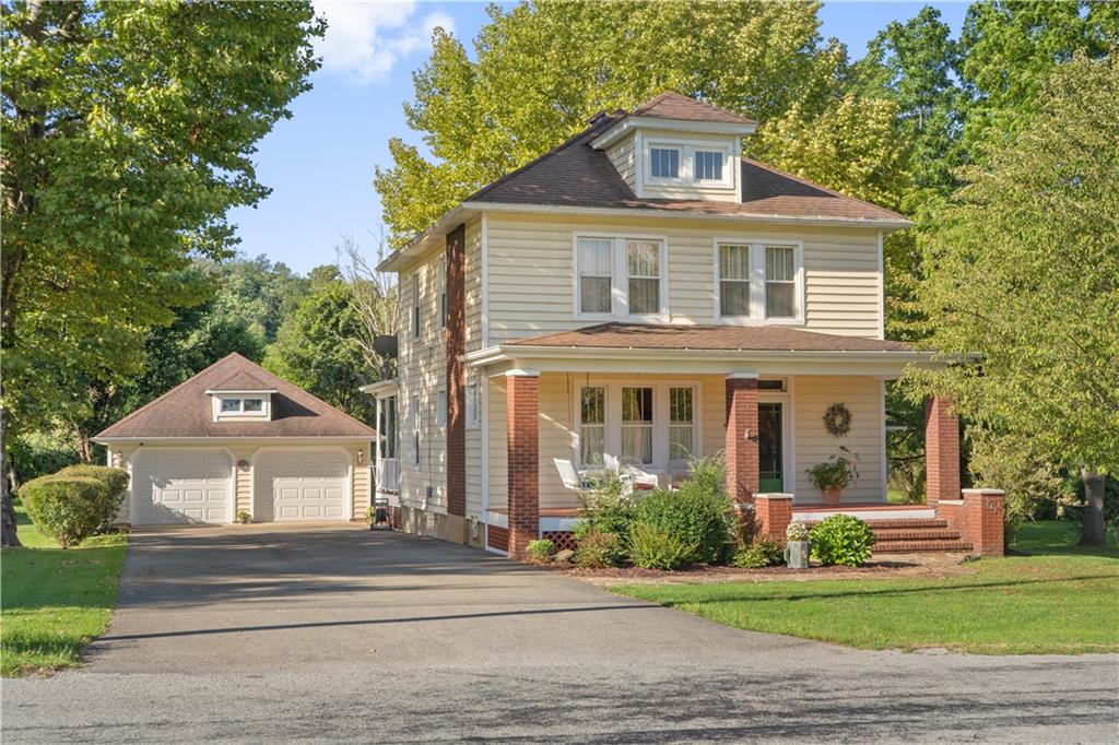 645 Cemetery Road Perryopolis, PA 15473 - Photo 1 of 31 a front view of a house with a garden