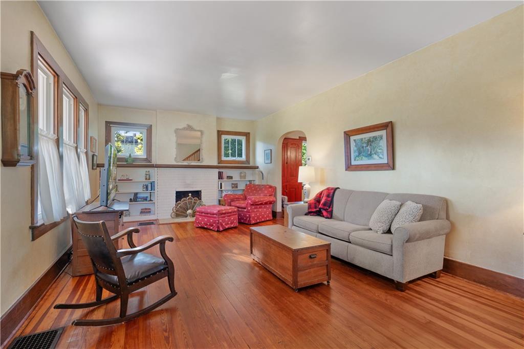 645 Cemetery Road Perryopolis, PA 15473 - Photo 20 of 31 a living room with fireplace furniture and a wooden floor
