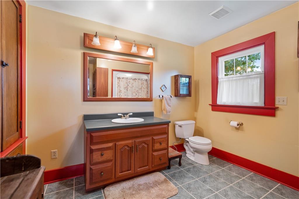 645 Cemetery Road Perryopolis, PA 15473 - Photo 21 of 31 a spacious bathroom with a toilet sink and mirror