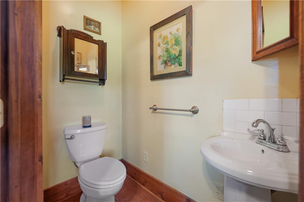 645 Cemetery Road Perryopolis, PA 15473 - Photo 8 of 31 a white toilet sitting next to a bathroom sink