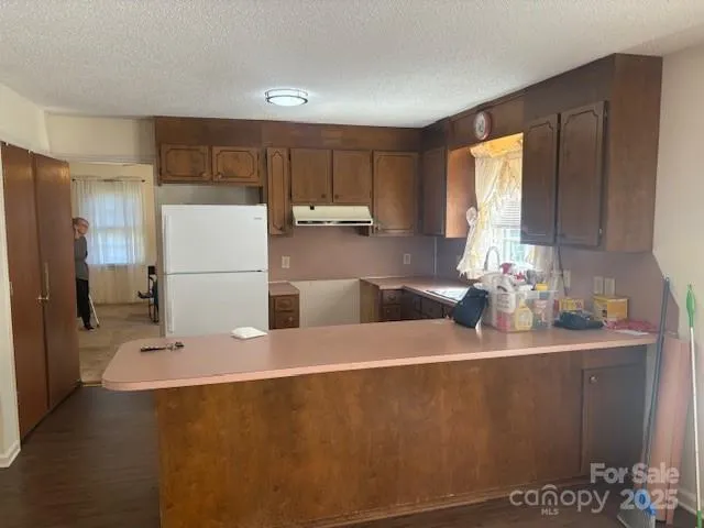 a kitchen with a sink a refrigerator and a stove