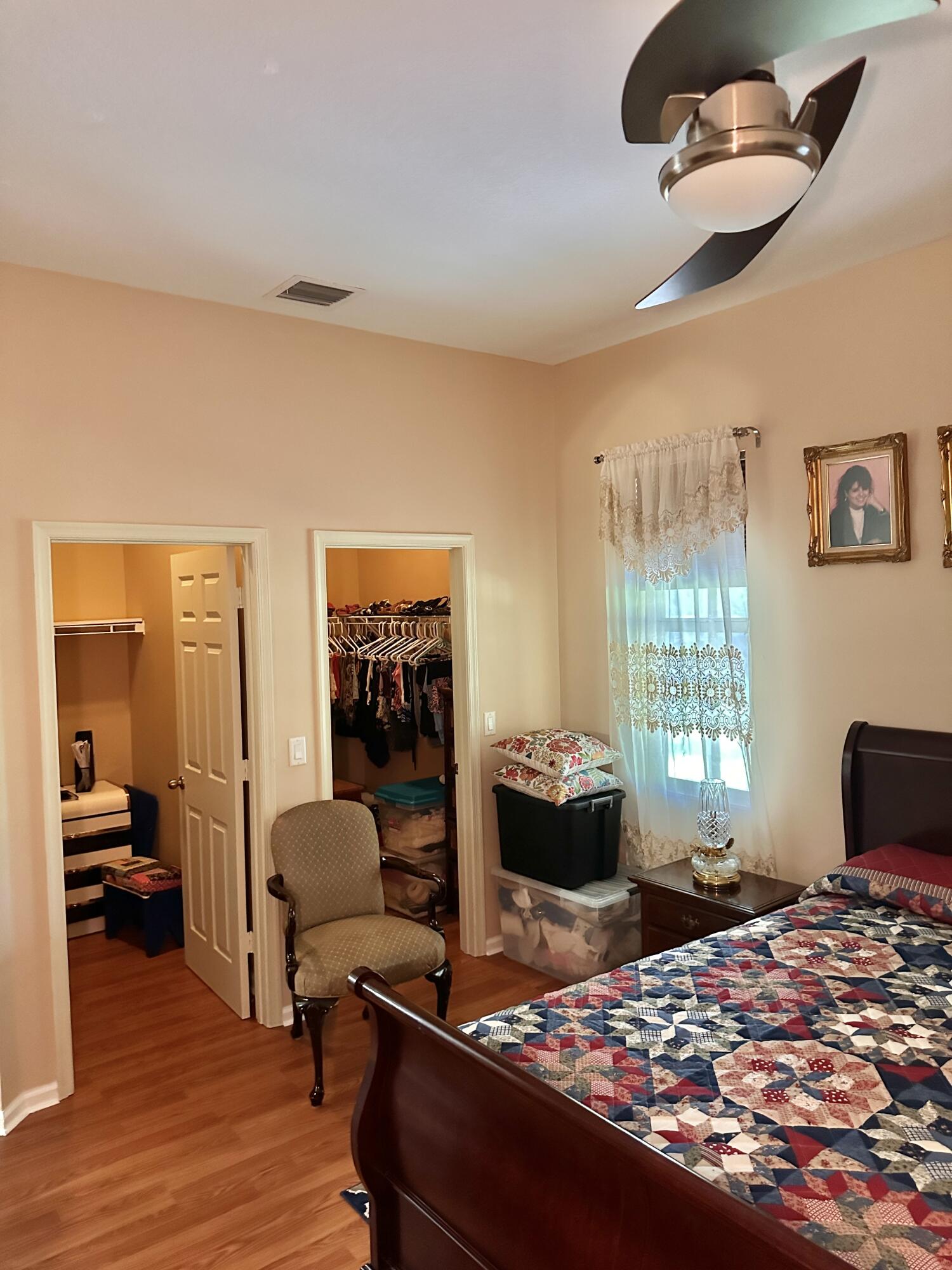 14085 86th Road North Loxahatchee, FL 33470 - Photo 20 of 28 a bedroom with a bed and wooden floor