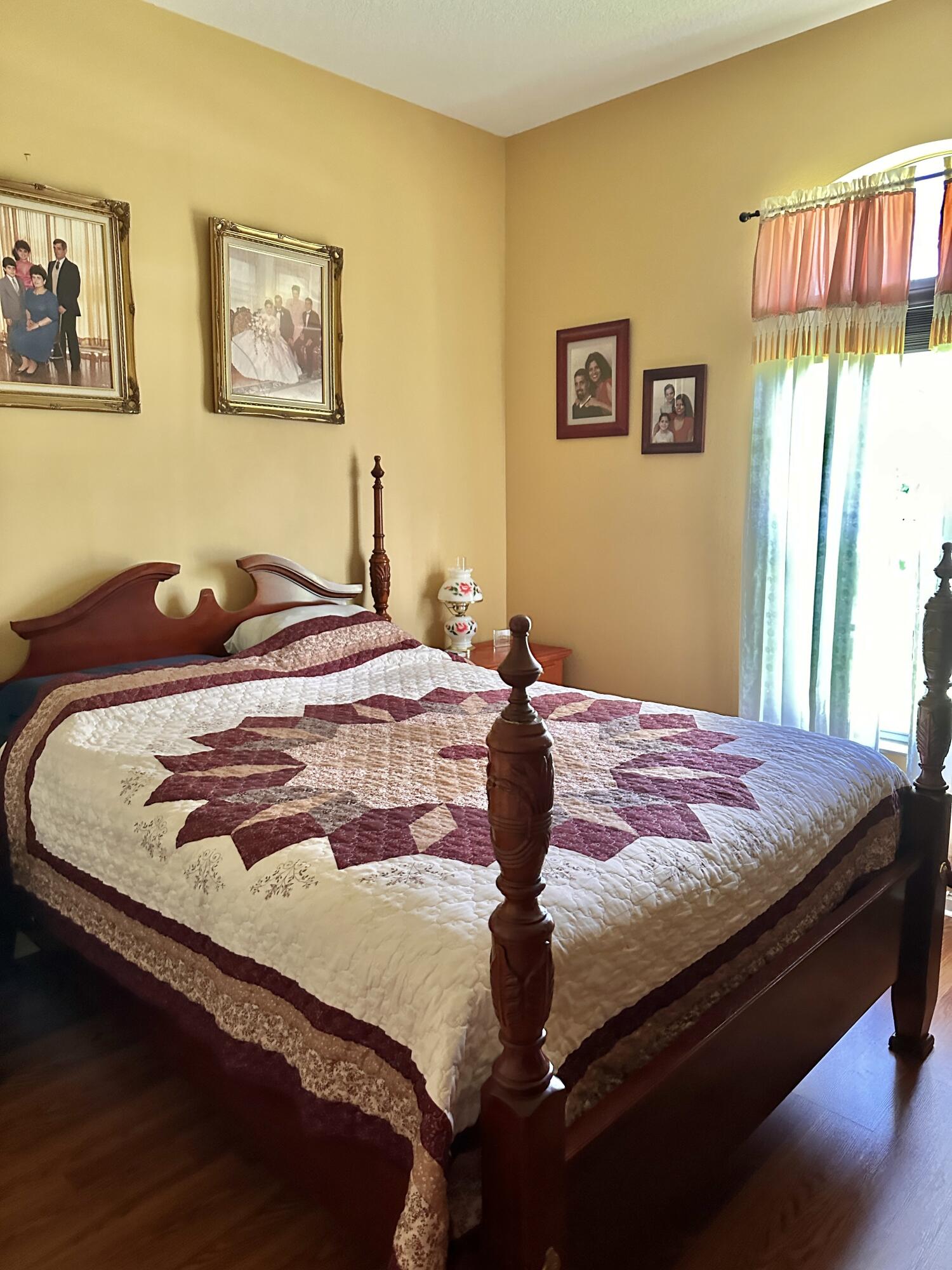 14085 86th Road North Loxahatchee, FL 33470 - Photo 24 of 28 a bedroom with a bed and painting on the wall