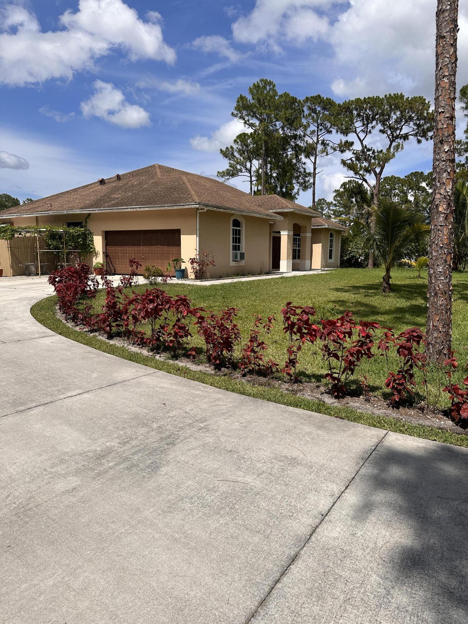 14085 86th Road North Loxahatchee, FL 33470 - Photo 4 of 28 front view of a house with a street