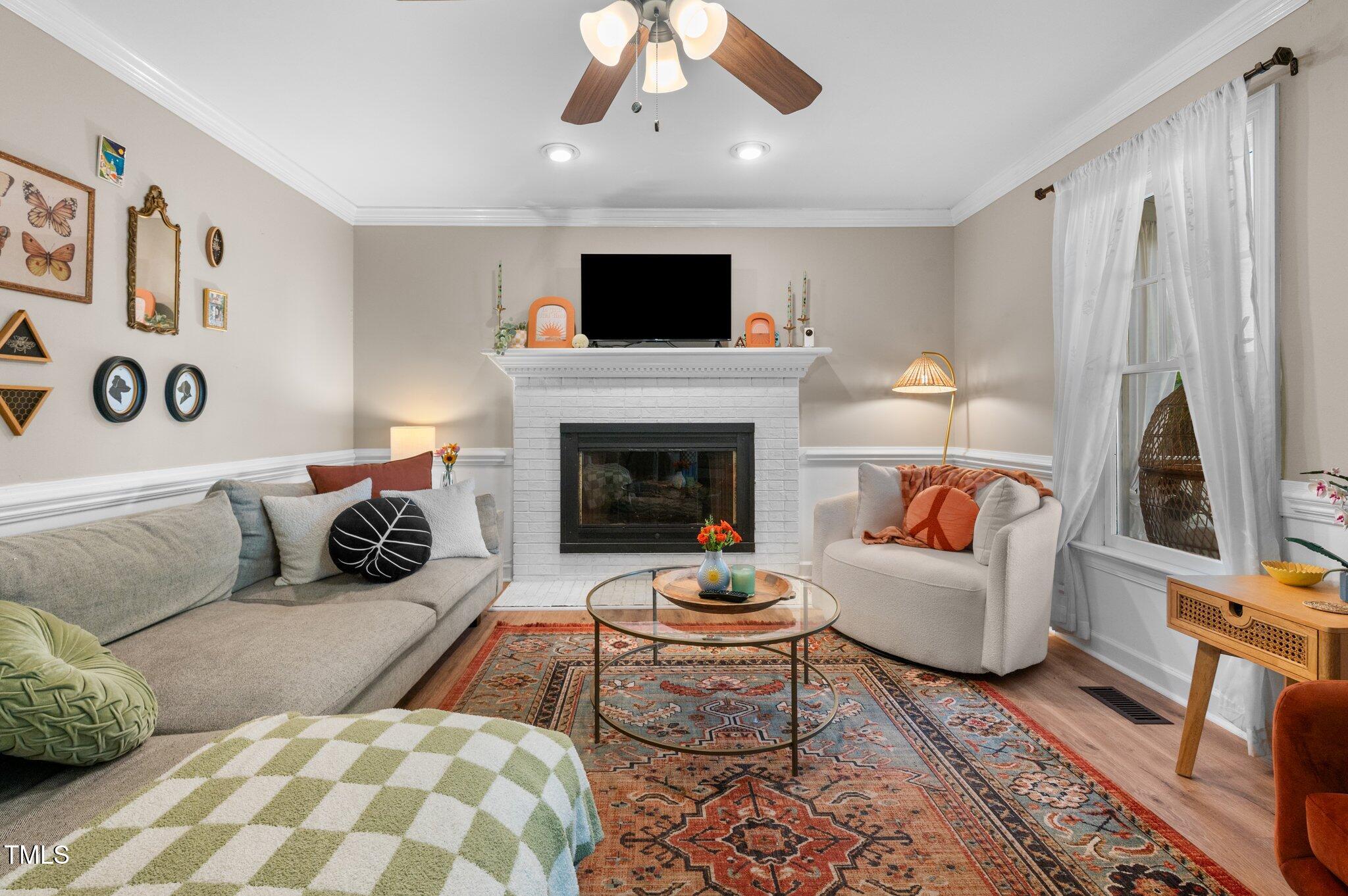 3541 East Jameson Road Raleigh, NC 27604 - Photo 3 of 38 a living room with furniture fireplace and flat screen tv