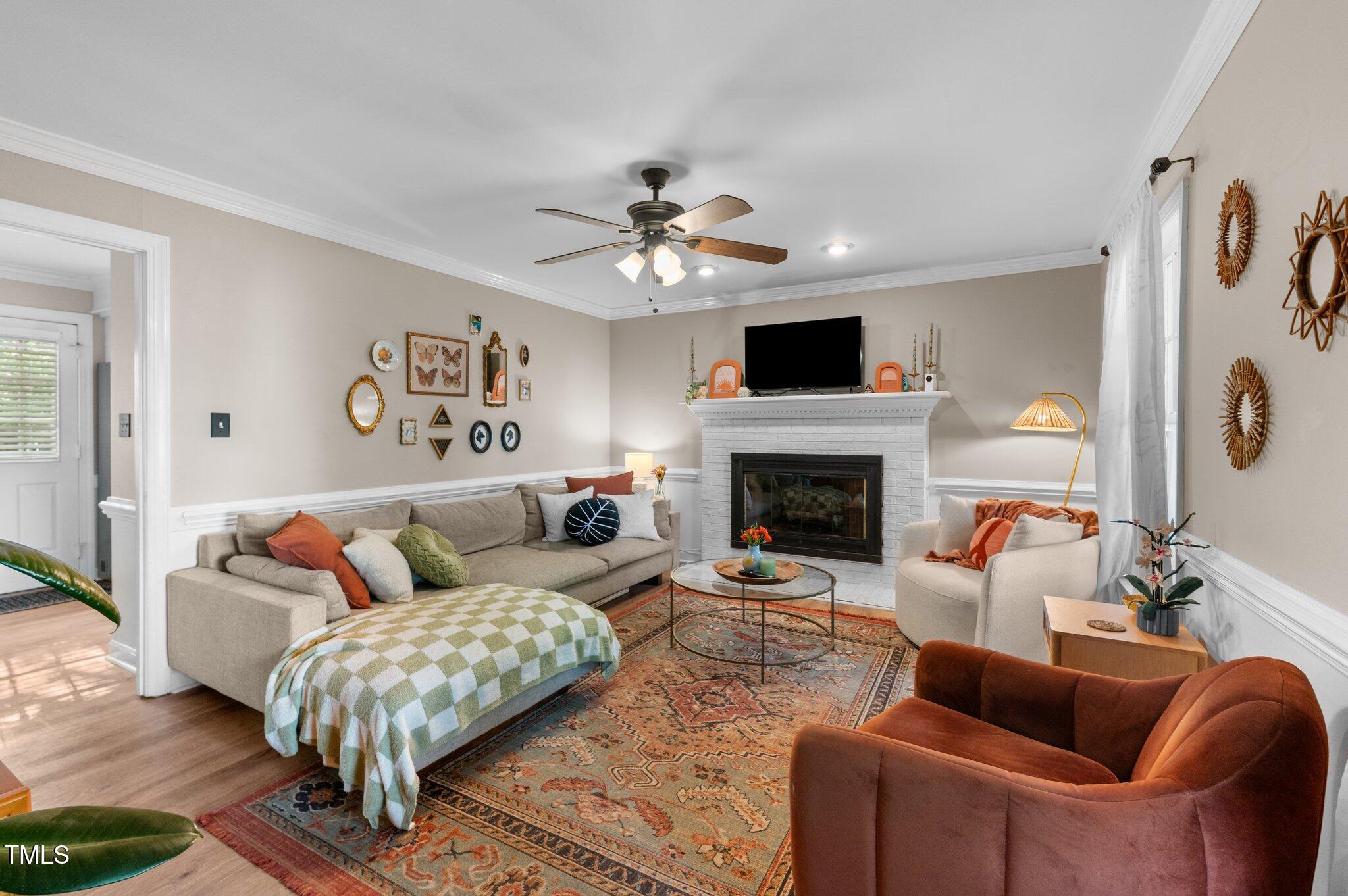 3541 East Jameson Road Raleigh, NC 27604 - Photo 10 of 38 a living room with furniture a fireplace and a flat screen tv
