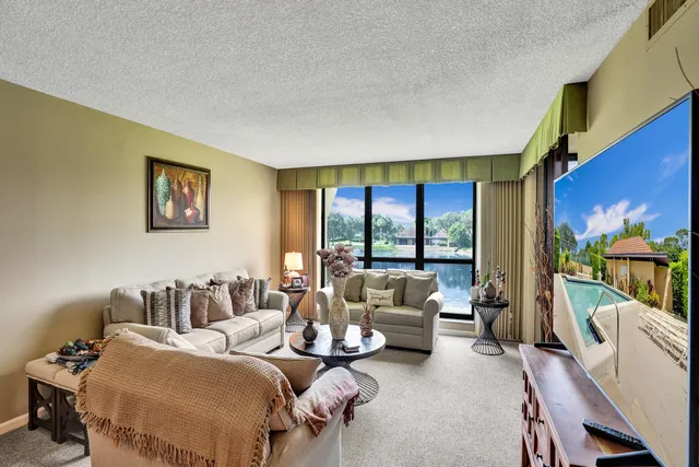 a bedroom with furniture and a large window