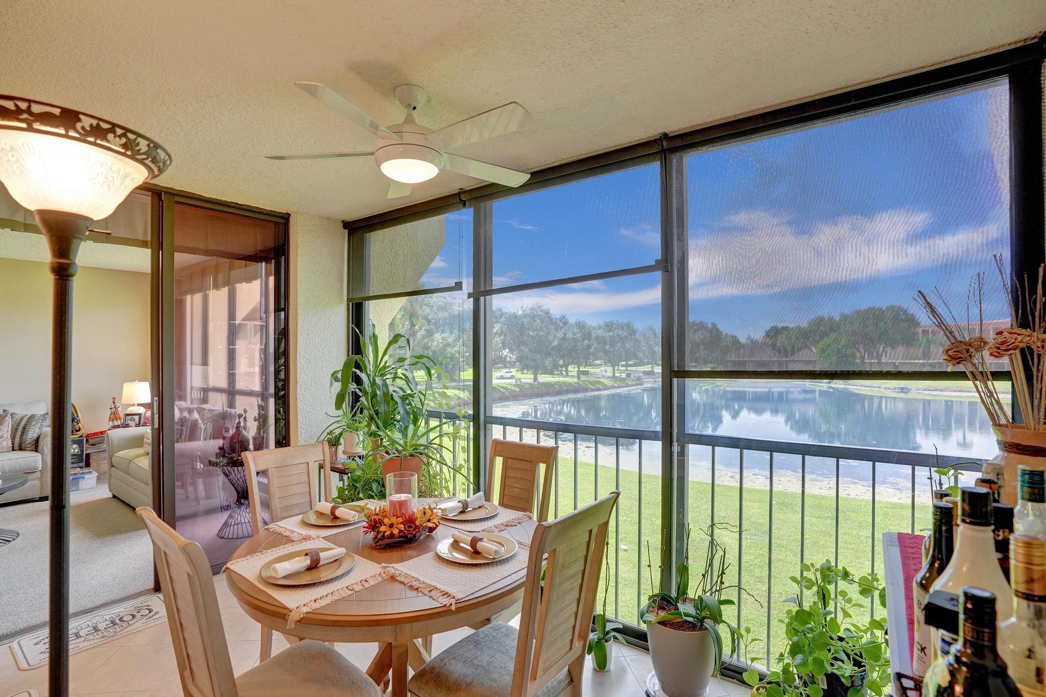 5344 Woodland Lakes Drive, Unit 223 Palm Beach Gardens, FL 33418 - Photo 23 of 46 a view of a dining room with furniture window and outside view