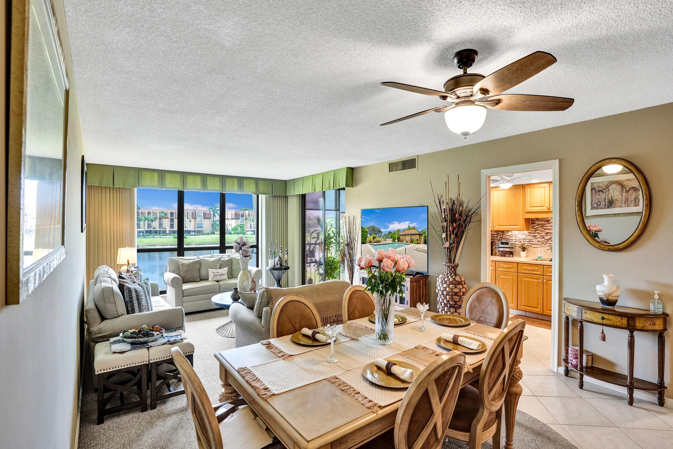 5344 Woodland Lakes Drive, Unit 223 Palm Beach Gardens, FL 33418 - Photo 9 of 46 a view of a dining room with furniture a chandelier and large window
