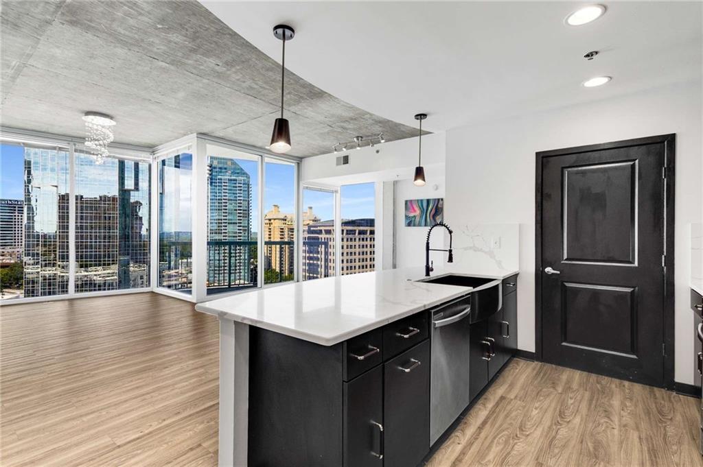 3324 Peachtree Road Northeast, Unit 1419 Atlanta, GA 30326 - Photo 1 of 43 a kitchen with a refrigerator a sink and wooden floor