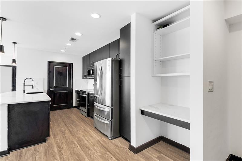 3324 Peachtree Road Northeast, Unit 1419 Atlanta, GA 30326 - Photo 2 of 43 a kitchen with a refrigerator and a sink