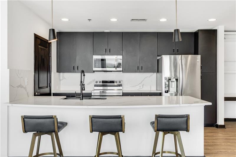 3324 Peachtree Road Northeast, Unit 1419 Atlanta, GA 30326 - Photo 3 of 43 a kitchen with stainless steel appliances a refrigerator and a stove top oven
