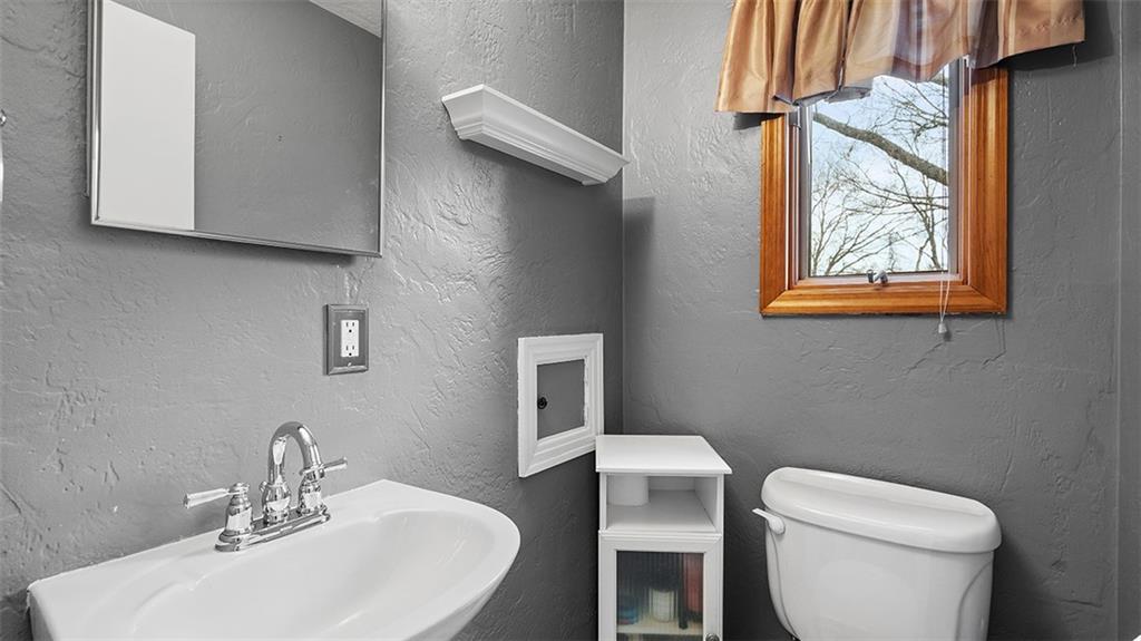 4720 Rolling Hills Road Pittsburgh, PA 15236 - Photo 15 of 34 a bathroom with a toilet a sink and a mirror