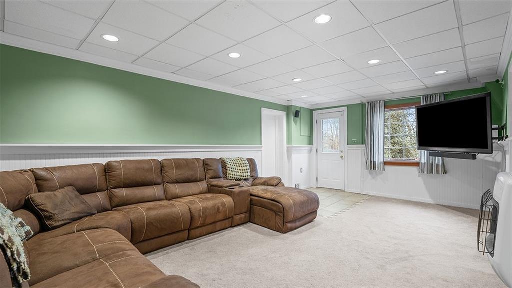 4720 Rolling Hills Road Pittsburgh, PA 15236 - Photo 24 of 34 a living room with furniture and a flat screen tv