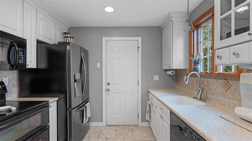4720 Rolling Hills Road Pittsburgh, PA 15236 - Photo 10 of 34 a kitchen with stainless steel appliances granite countertop a refrigerator and a sink