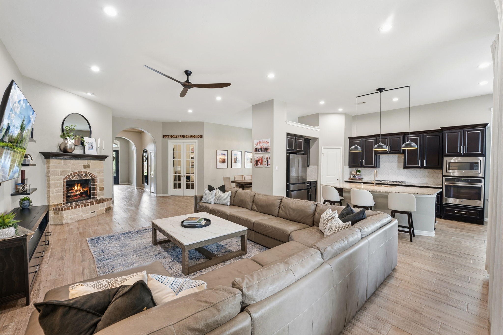 27906 Arden Trail Spring, TX 77386 - Photo 19 of 49 a living room with furniture a fireplace and a kitchen view