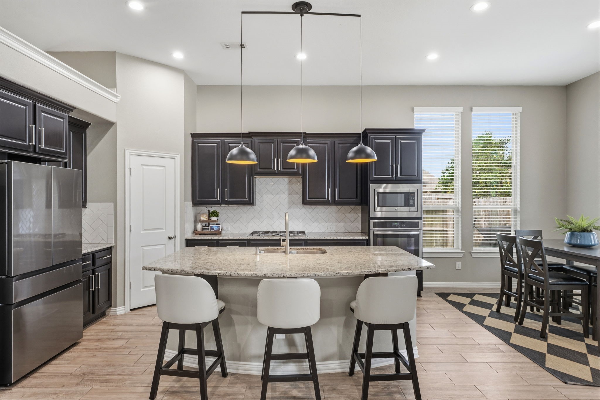 27906 Arden Trail Spring, TX 77386 - Photo 23 of 49 a kitchen with stainless steel appliances granite countertop a stove top oven a refrigerator a sink and chairs