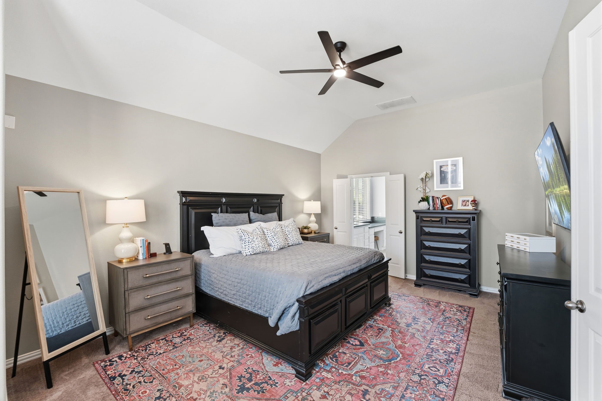 27906 Arden Trail Spring, TX 77386 - Photo 30 of 49 a bedroom with a bed and a chandelier