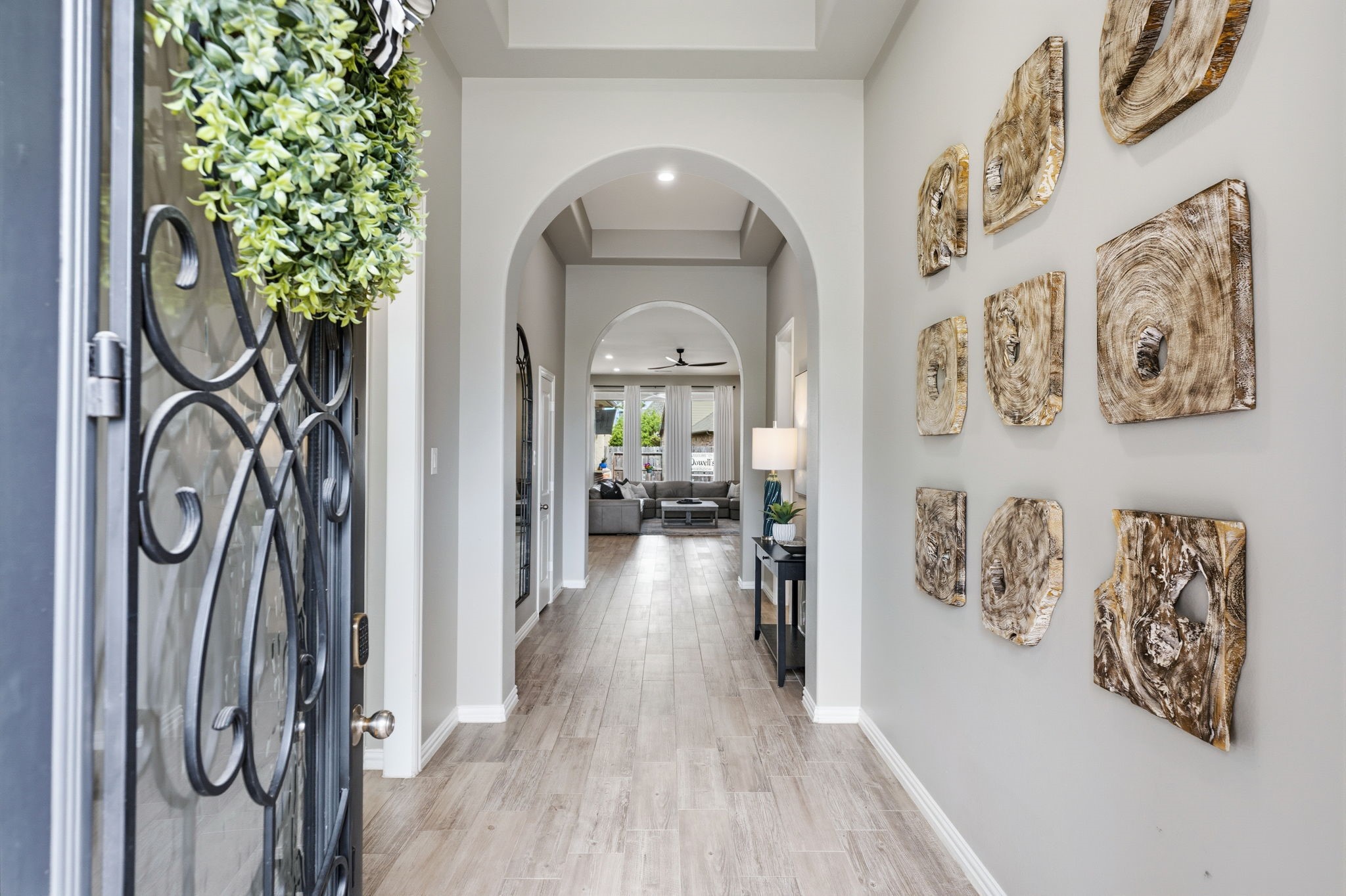 27906 Arden Trail Spring, TX 77386 - Photo 3 of 49 a view of a hallway to a livingroom with wooden floor and a chandelier