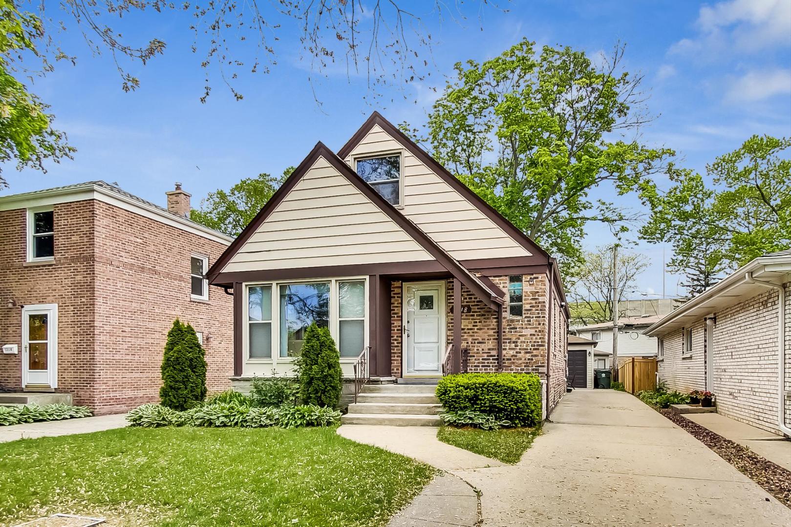 1218 Elliott Street Park Ridge, IL 60068 - Photo 2 of 24 a front view of a house with a yard and potted plants