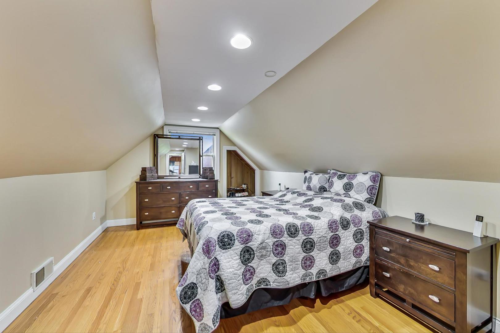 1218 Elliott Street Park Ridge, IL 60068 - Photo 13 of 24 a bedroom with a bed and wooden floor
