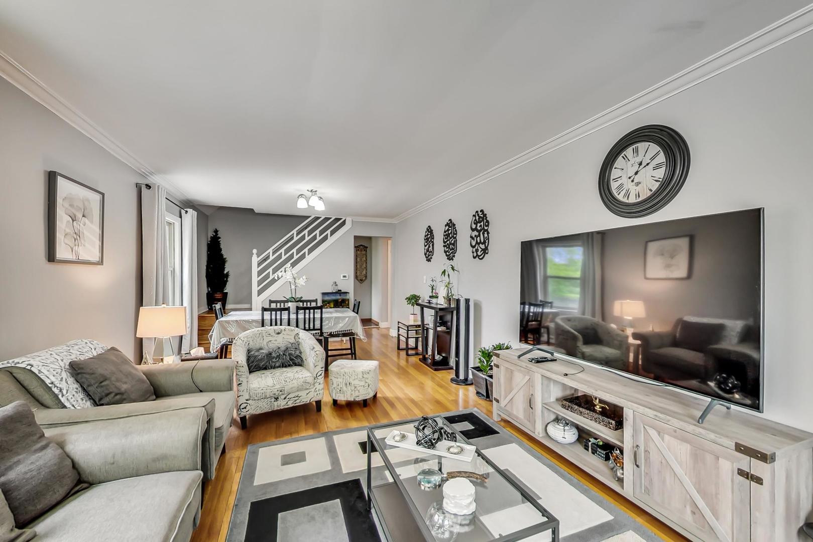 1218 Elliott Street Park Ridge, IL 60068 - Photo 5 of 24 a living room with furniture a clock on wall and a window