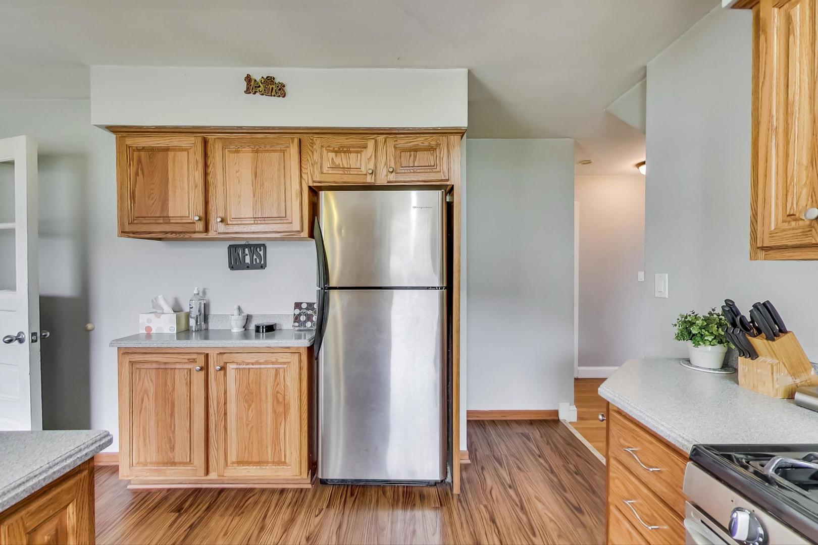 1218 Elliott Street Park Ridge, IL 60068 - Photo 9 of 24 a kitchen with a refrigerator and a stove top oven