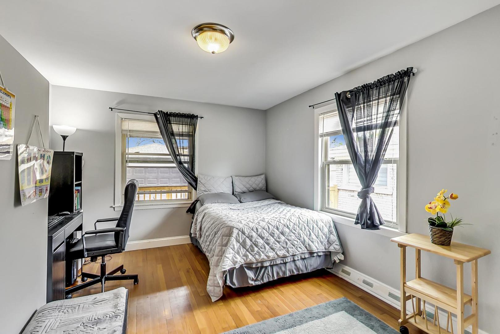 1218 Elliott Street Park Ridge, IL 60068 - Photo 10 of 24 a bedroom with a bed and wooden floor