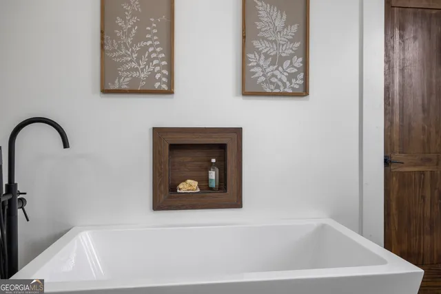 a view of swimming pool with lawn chairs and plants