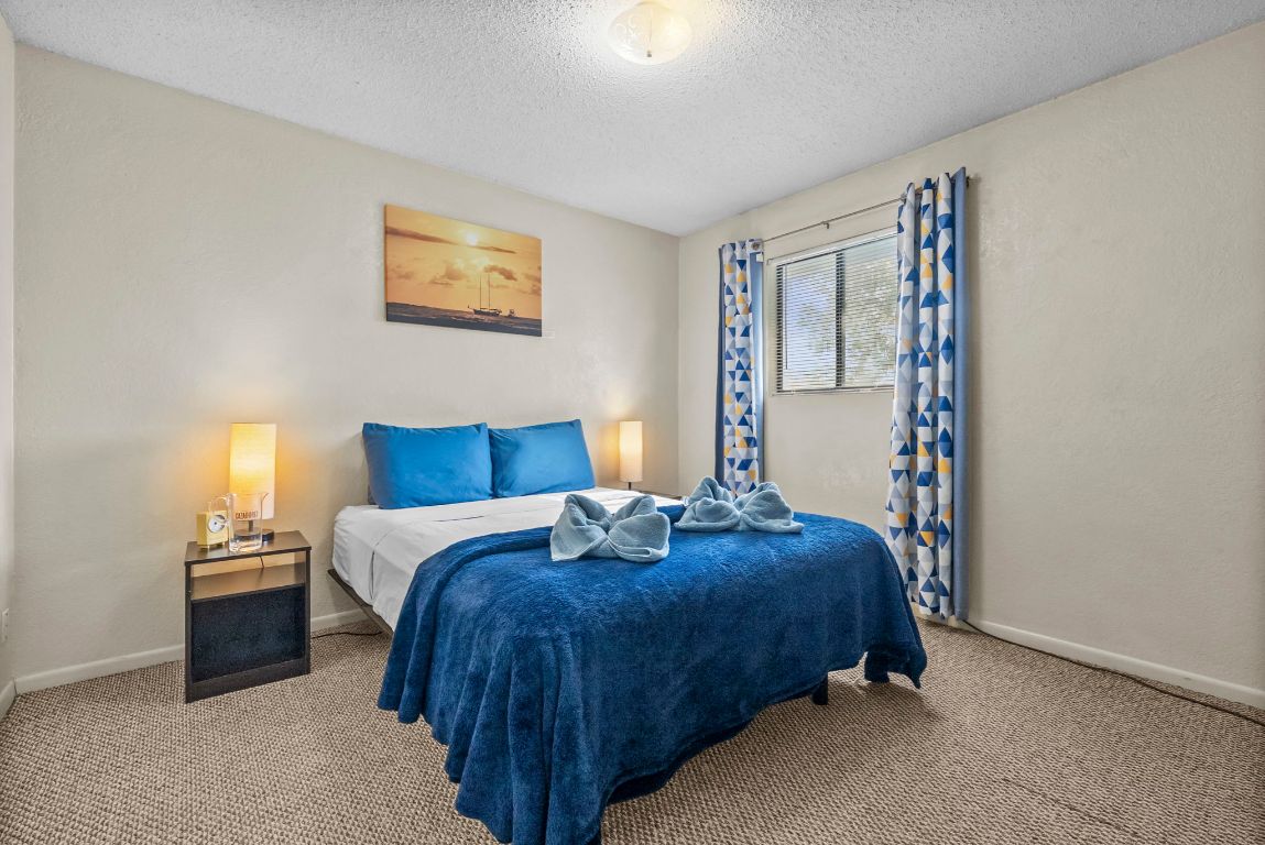 202 West Wheeler Street Manor, TX 78653 - Photo 10 of 28 a bedroom with bed and night stand