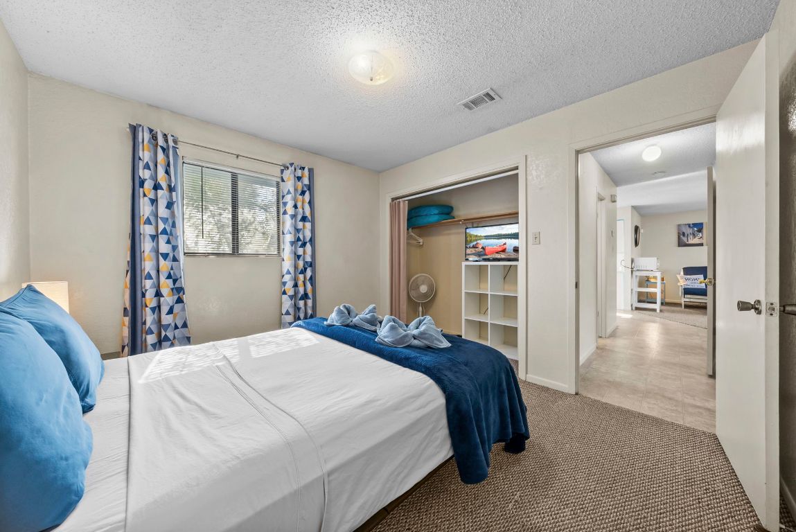 202 West Wheeler Street Manor, TX 78653 - Photo 11 of 28 a bedroom with a large bed and a window