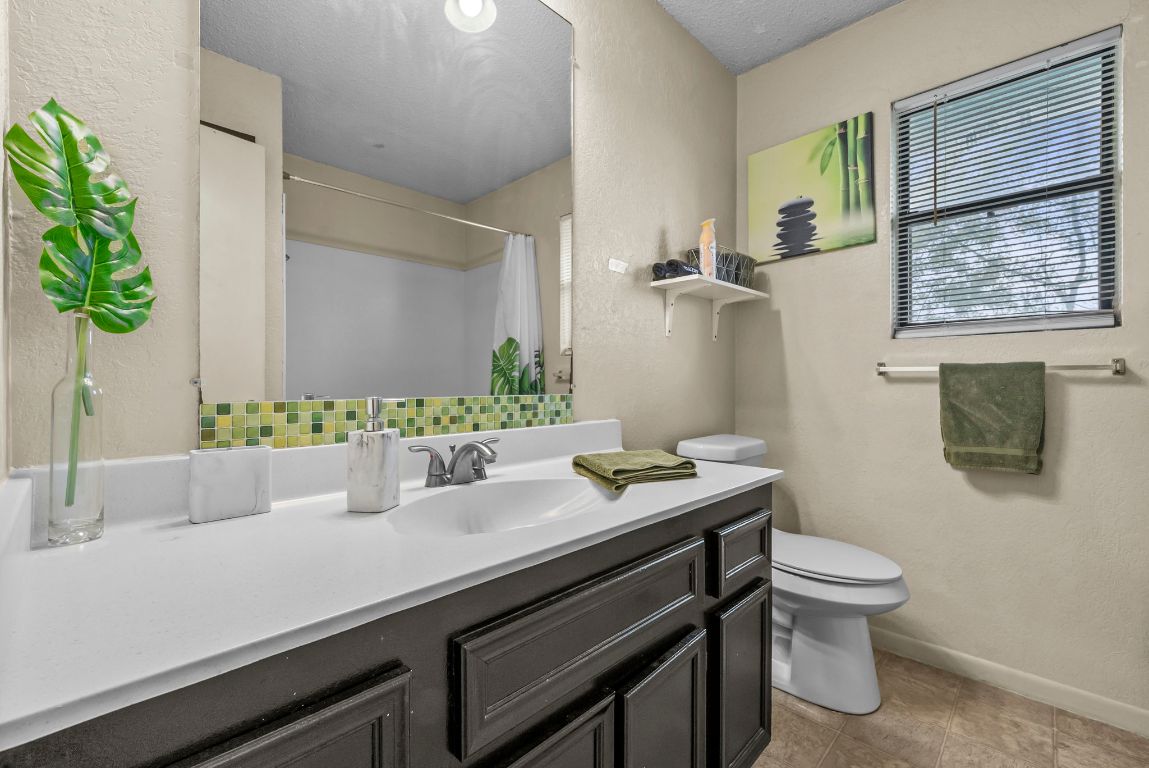 202 West Wheeler Street Manor, TX 78653 - Photo 12 of 28 a bathroom with a sink and a toilet