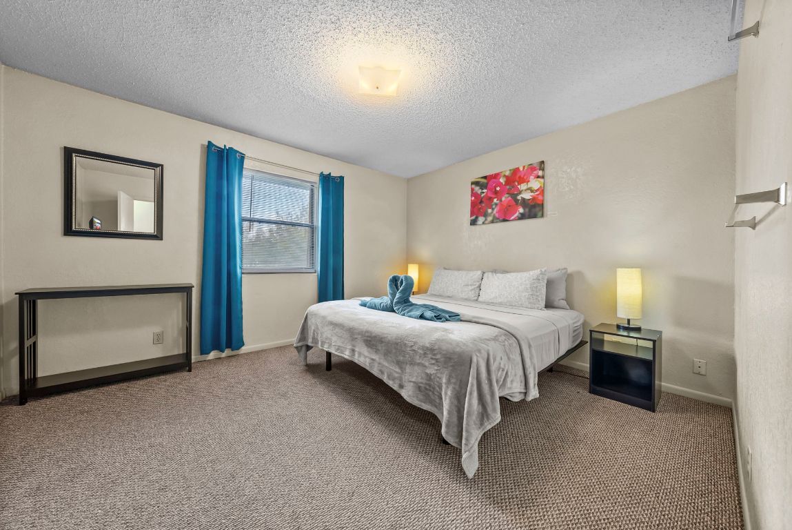 202 West Wheeler Street Manor, TX 78653 - Photo 13 of 28 a spacious bedroom with a bed and a cabinets