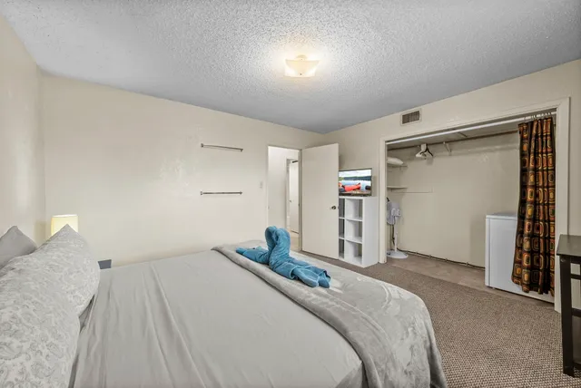 a bedroom with a large bed and a window