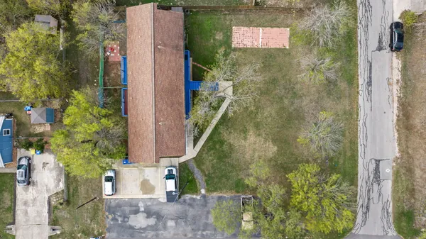 a house view with swimming pool in front of it